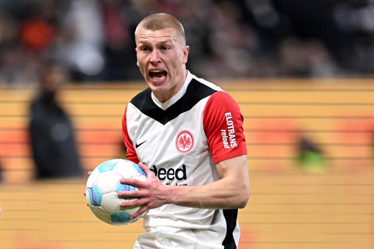 Frankfurt's Danish defender #13 Rasmus Kristensen holds the ball as he reacts during the German first division Bundesliga football match between Eintracht Frankfurt and VfB Stuttgart in Frankfurt on March 29, 2025.  Kirill KUDRYAVTSEV / AFP