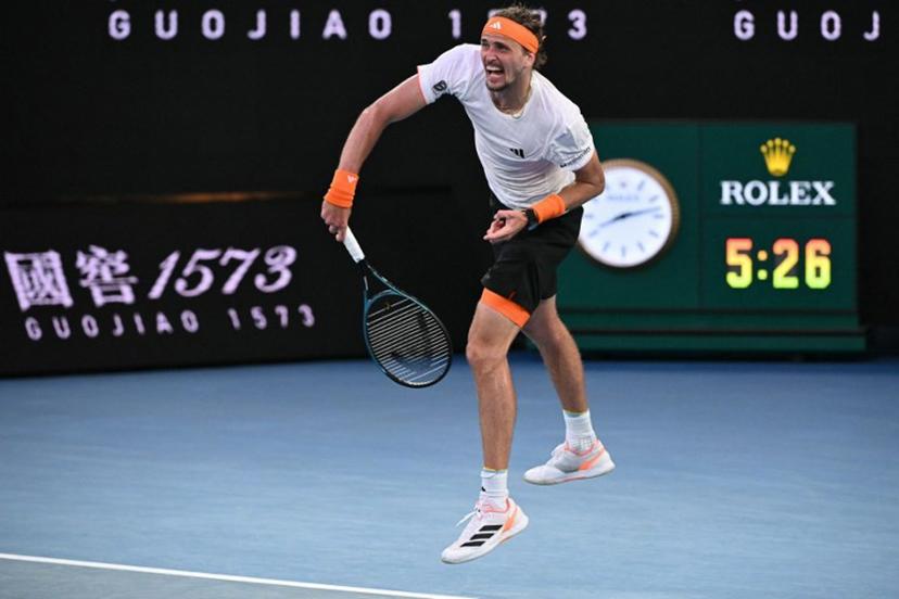 Germany's Alexander Zverev serves to Spain's Carlos Alcaraz at the end of their men's singles semi-final match on day thirteen of the Australian Open tennis tournament in Melbourne on January 30, 2026.  WILLIAM WEST / AFP