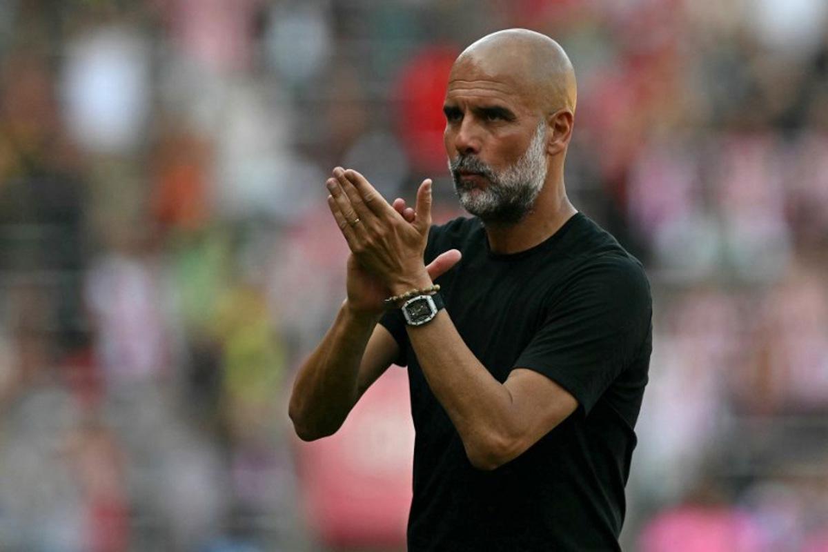 Manchester City's Spanish manager Pep Guardiola applauds fans on the pitch after the English Premier League football match between Southampton and Manchester City at St Mary's Stadium in Southampton, southern England on May 10, 2025. The game finished 0-0. Glyn KIRK / AFP