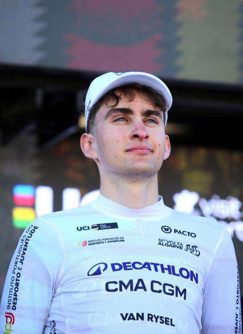 Decathlon CMA CGM Team French cyclist Paul Seixas stands on the podium wearing the best young rider's white jersey after the stage four of the Algarve Tour, a 182.10 km race from Albufeira to Lagos, on February 21, 2026.  João Matos / AFP