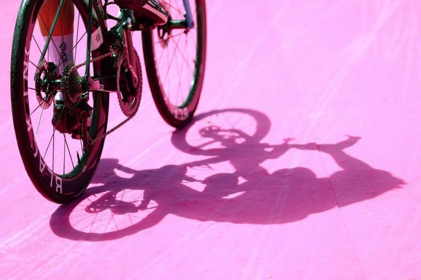 A photograph shows the shadows of a rider arriving to attend the signature ceremony ahead of the start of the stage 1 of the Giro d'Italia 2024 cycling race, 140 km between Venaria Reale and Torino on May 4, 2024.  The 107th edition of the Giro d'Italia, with a total of 3400,8 km, departs from Veneria Reale near Turin on May 4, 2024 and will finish in Rome on May 26, 2024. Luca Bettini / AFP