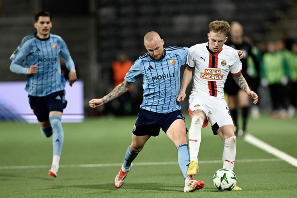 Djurgarden's Adam Stahl and Rapid Vienna's Isak Jansson vie for the ball during the quarter-final Conference League football match 1 of 2, between Djurgarden and SK Rapid Vienna in Stockholm on April 10, 2025.  Pontus LUNDAHL / TT NEWS AGENCY / AFP
