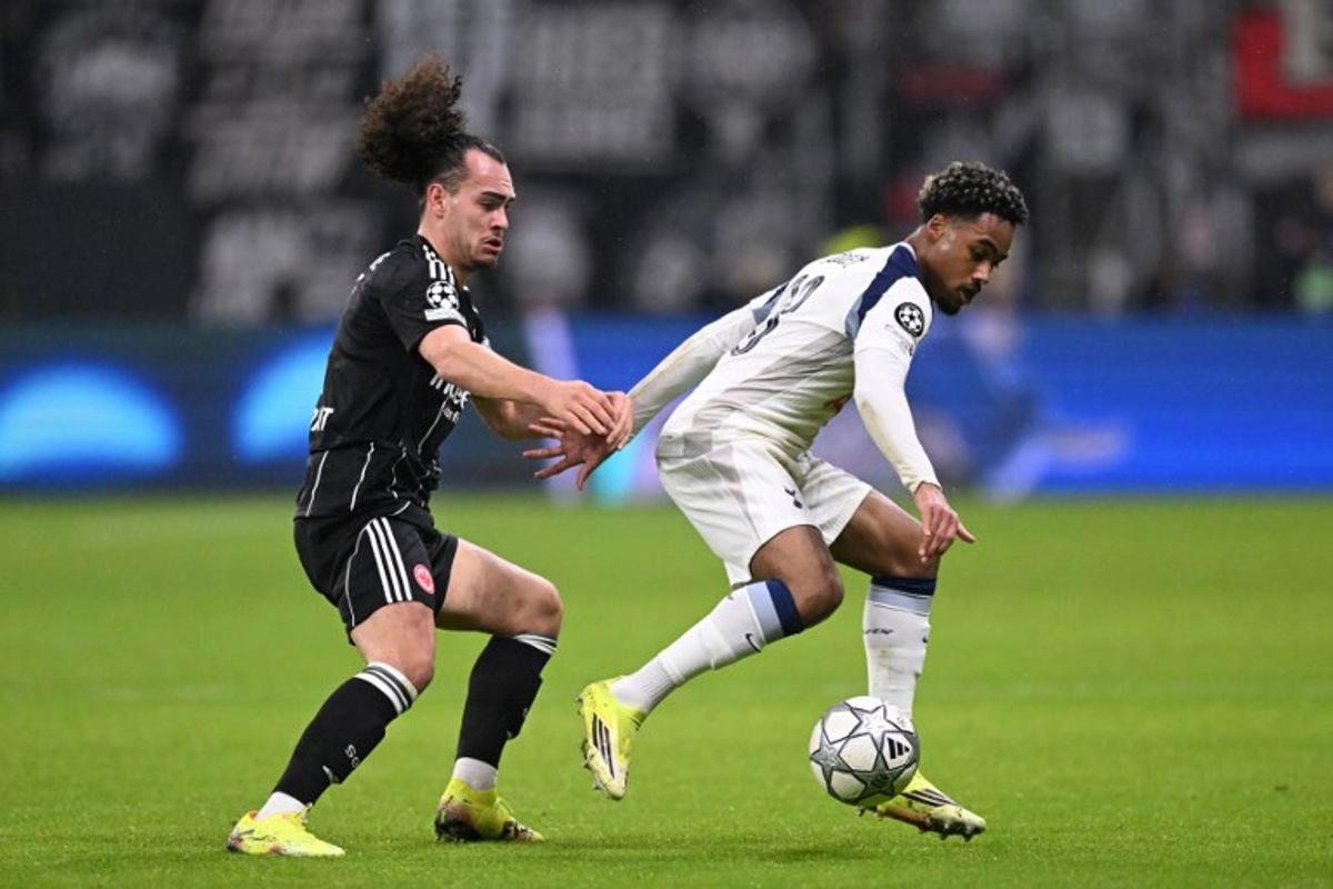 Frankfurt's Belgian defender #03 Arthur Theate and Tottenham Hotspur's French midfielder #28 Wilson Odobert vie for the ball during the UEFA Champions League league phase- day 8 football match between Eintracht Frankfurt and Tottenham Hotspur in Frankfurt, western Germany, on January 28, 2026.  Kirill KUDRYAVTSEV / AFP