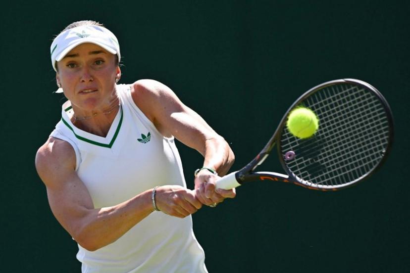 Ukraine's Elina Svitolina plays a backhand return to Hungary's Anna Bondar during their women's singles first round tennis match on the first day of the 2025 Wimbledon Championships at The All England Lawn Tennis and Croquet Club in Wimbledon, southwest London, on June 30, 2025.  Glyn KIRK / AFP