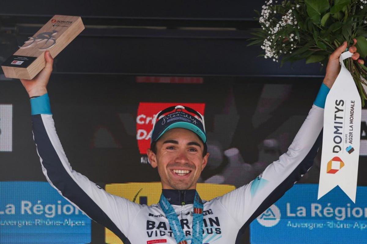 Bahrain Victorious's French rider Lenny Martinez celebrates winning the stage on the podium of the 8th and final stage of the 77th edition of the Criterium du Dauphine cycling race, 133,3 km between Val-d'Arc and Val-Cenis - Plateau du Mont Cenis, on June 15, 2025.  Anne-Christine POUJOULAT / AFP