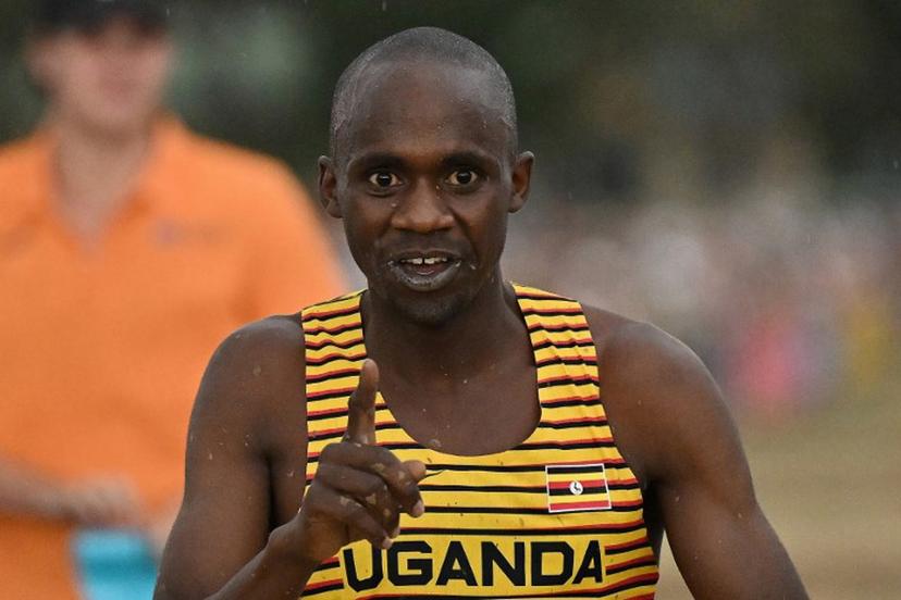 Uganda's Jacob Kiplimo celebrates after crossing the finish line to win the men's senior race during the 2023 World Cross Country Championships at Mount Panorama in Bathurst on February 18, 2023.   Saeed KHAN / AFP