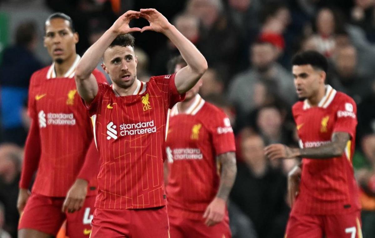 Liverpool's Portuguese striker #20 Diogo Jota (2L) celebrates scoring the opening goal during the English Premier League football match between Liverpool and Everton at Anfield in Liverpool, north west England on April 2, 2025.  Paul ELLIS / AFP