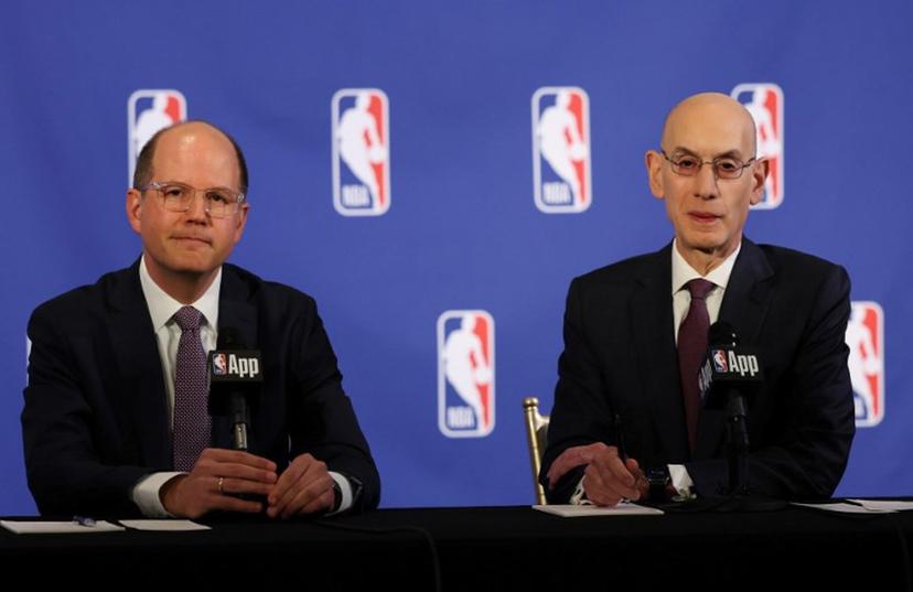 FIBA Secretary General Andreas Zagklis (L) and NBA commissioner Adam Silver (R) speak during a press conference to announce the NBA's ongoing quest to further align with FIBA and expand its role in European basketball, in New York, on March 27, 2025.  TIMOTHY A. CLARY / AFP