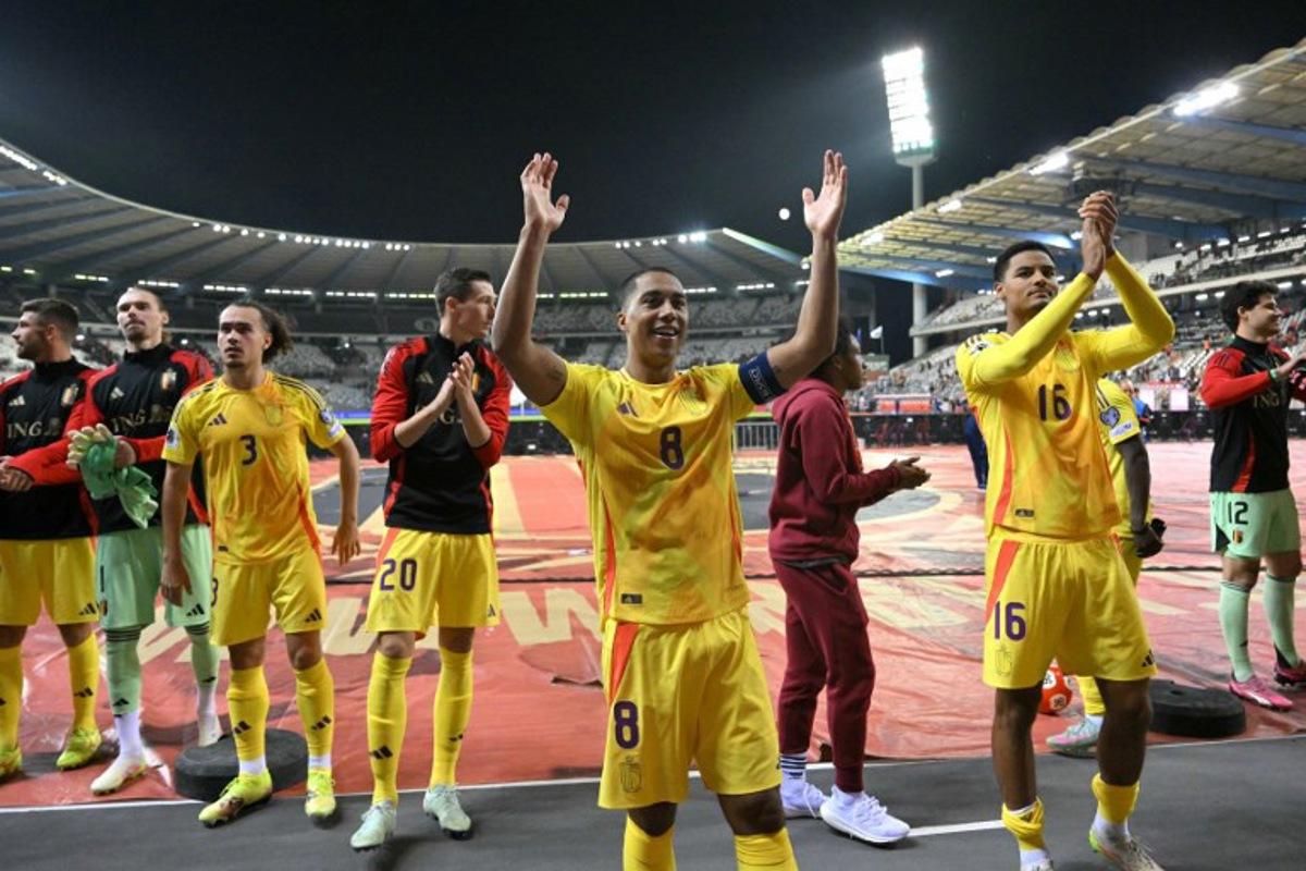 Belgium's midfielder #08 Youri Tielemans (C) celebrates with his teammates in front of Belgium fans at the end of the FIFA World Cup 2026 Group J European qualification football match between Belgium and Wales at the King Baudouin Stadium in Brussels, on June 9, 2025.  NICOLAS TUCAT / AFP
