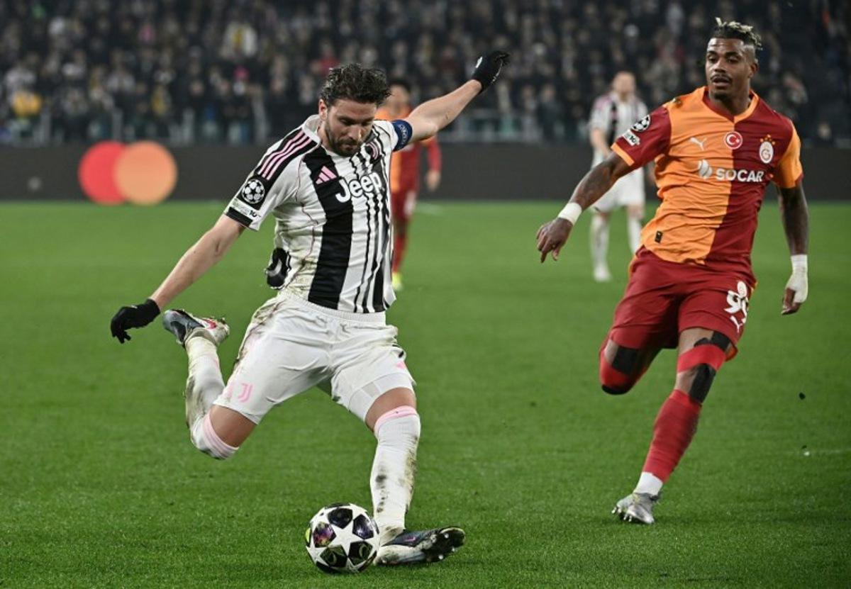 Juventus' Italian midfielder #5 Manuel Locatelli (L) kicks the ball next to Galatasaray's Gabonese midfielder #99 Mario Lemina (R) during the UEFA Champions League, knockout round play-off second leg, football match between Juventus FC and Galatasaray SK at the Allianz stadium in Turin, on February 25, 2026.  Isabella BONOTTO / AFP