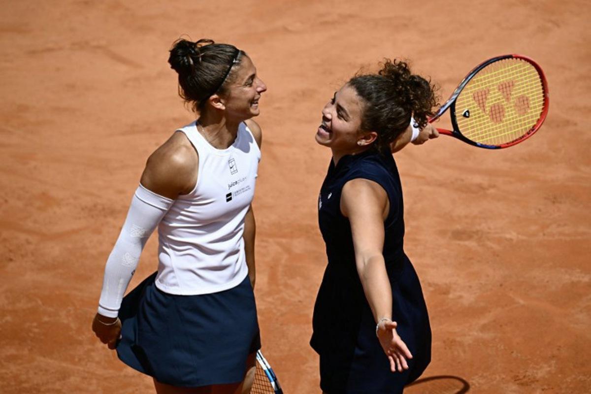 Italy's Jasmine Paolini (r) and Sara Errani (l) celebrate at the end of their women's doubles final match against Russia's Veronika Kudermetova and Belgium's Elise Mertens for the ATP Rome Open tennis tournament at Foro Italico in Rome on May 18, 2025.   Filippo MONTEFORTE / AFP