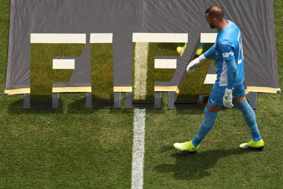 Palmeiras' Brazilian goalkeeper #21 Weverton walks in front of a FIFA logo ahead of the FIFA Club World Cup 2025 round of 16 all-Brazilian football match between Palmeiras and Botafogo at Lincoln Financial Field Stadium in Philadelphia on June 28, 2025.  CHARLY TRIBALLEAU / AFP