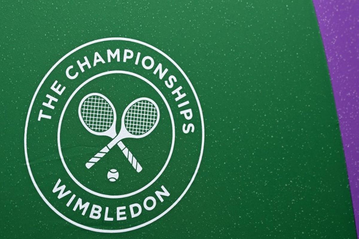 A Wimbledon umbrella is pictured on court 2 on the sixth day of the 2024 Wimbledon Championships at The All England Lawn Tennis and Croquet Club in Wimbledon, southwest London, on July 6, 2024.  Glyn KIRK / AFP