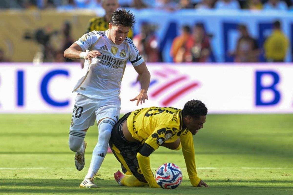 Real Madrid's Spanish defender #20 Francisco Garcia and Borussia Dortmund's Belgian forward #16 Julien Duranville fight for the ball during the FIFA Club World Cup 2025 quarterfinal football match between Spain's Real Madrid and Germany's Borussia Dortmund at the MetLife stadium in East Rutherford, New Jersey on July 5, 2025.  JUAN MABROMATA / AFP