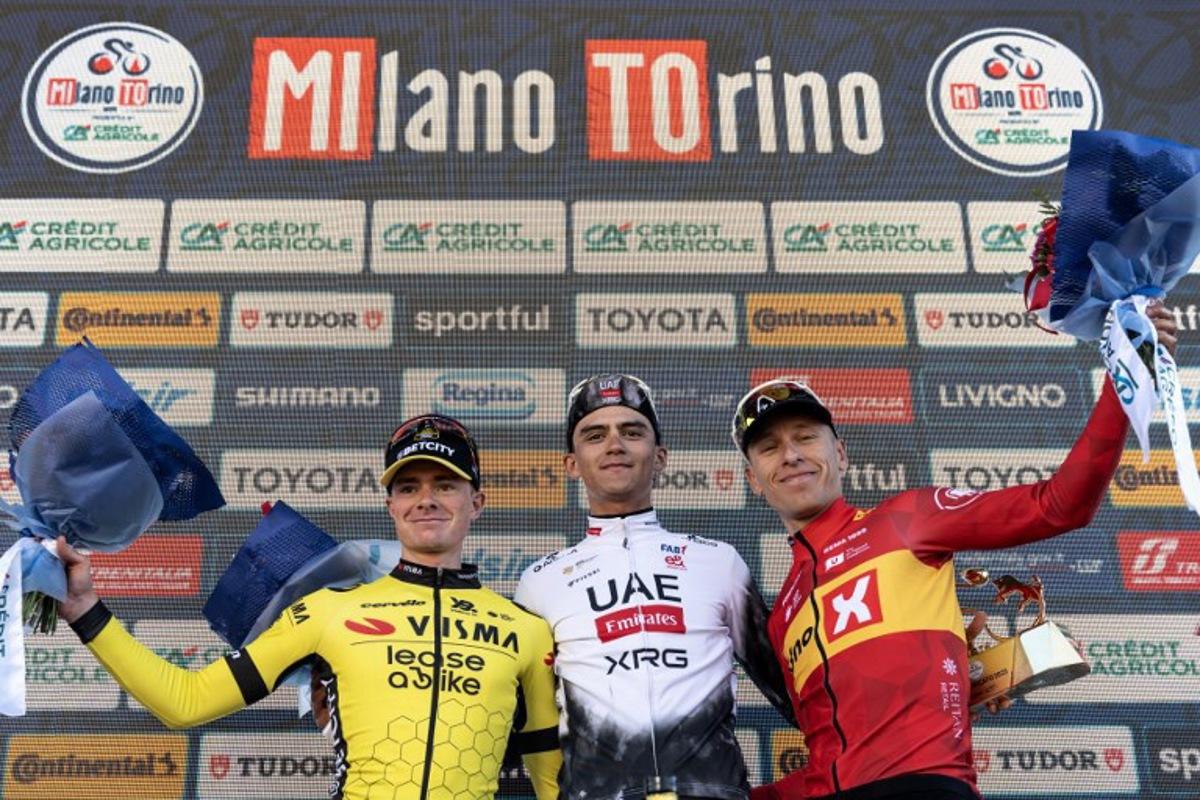 Second-placed Team Visma Lease a Bike, British Ben Tulett (L), winner Mexican Isaac Del Toro (C) and third Team Uno X Mobility Jonas Abrahamsen of Norway celebrate on the podium of the 106th edition of the one-day classic cycling race Milan - Torino between Rho, west of Milan, and Superga, east of Torino, on March 19, 2025.  MARCO BERTORELLO / AFP