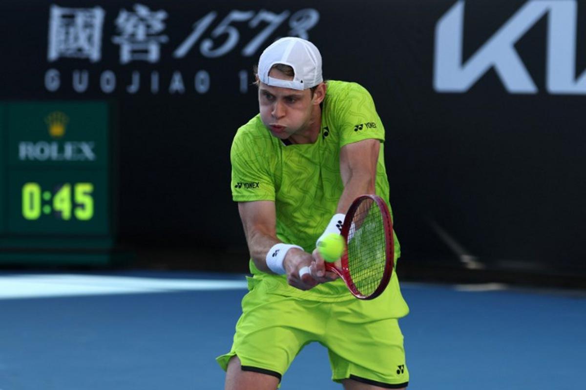 Belgium's Zizou Bergs hits a shot against Poland's Hubert Hurkacz during their men's singles match on day three of the Australian Open tennis tournament in Melbourne on January 20, 2026.  IZHAR KHAN / AFP