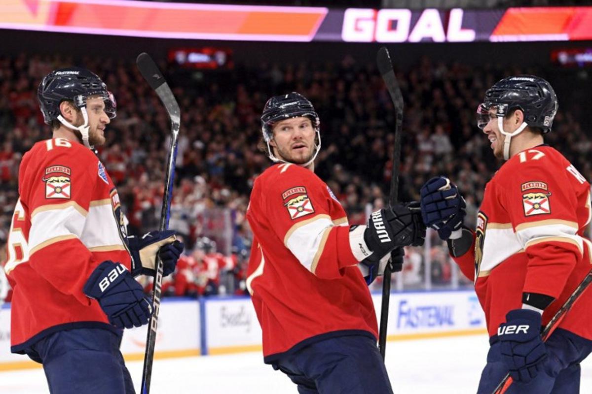 (L to R) Aleksander Barkov, Dmitry Kulikov and Evan Rodrigues of Florida celebrate the opening 0-1 goal by Rodrigues during the NHL Global Series Ice Hockey match Dallas Stars vs Florida Panthers in Tampere, Finland on November 2, 2024.  Heikki Saukkomaa / Lehtikuva / AFP