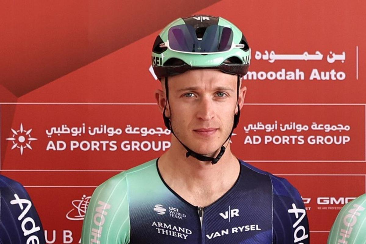 Decathlon CMA CGM Team's Belgian rider Robbe Ghys poses on stage ahead of the first stage of the UAE Tour cycling event from Madinat Zayed Majlis to Liwa Palace in Abu Dhabi on February 16, 2026.  Fadel SENNA / AFP