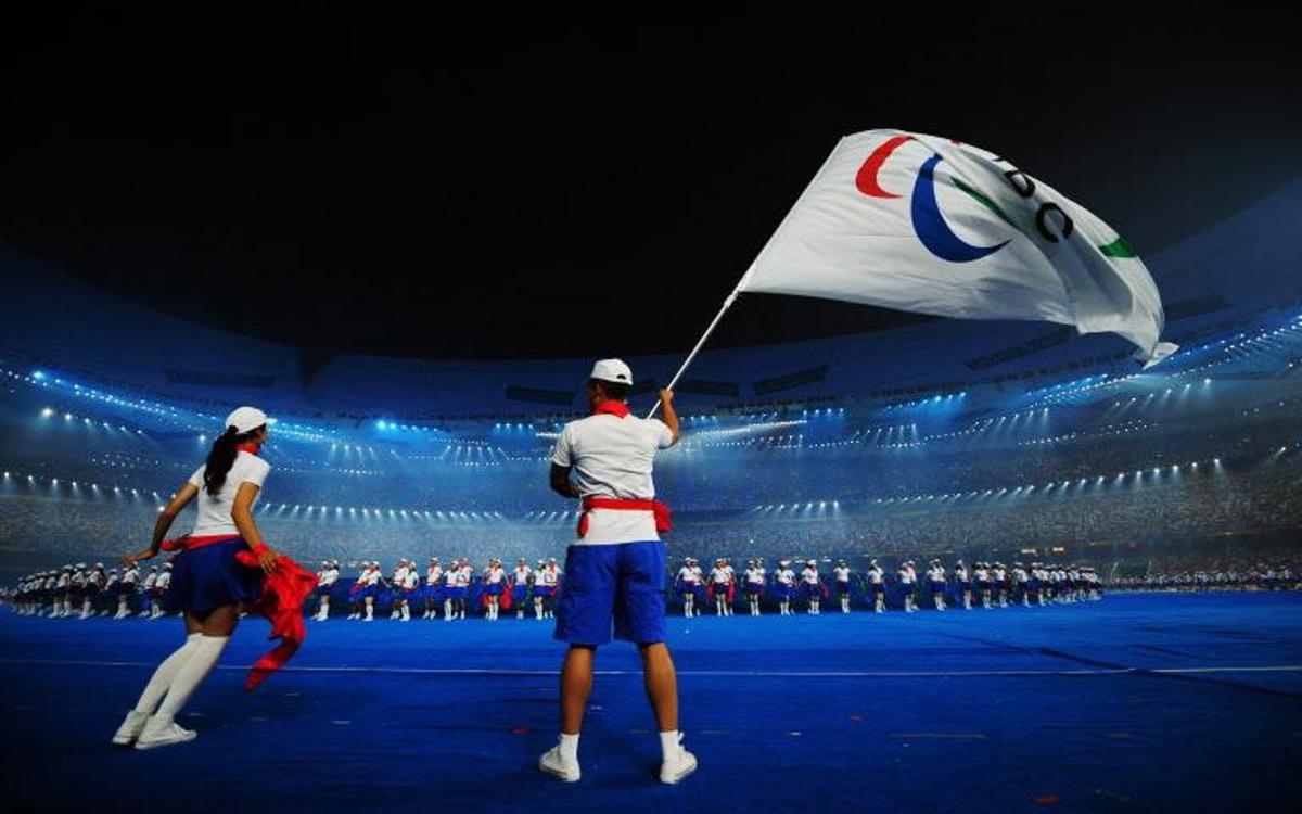 A performer waves the International Paralympic Committee (IPC) flag as the 2008 Beijing Paralympic Games opening ceremony kicks off at the National Stadium, better known as the Bird's Nest, in Beijing on September 6, 2008. More than 4,000 athletes were at the opening of what promises to be a dazzling Paralympics, with the head of the international movement predicting a fantastic Games.     AFP PHOTO/FREDERIC J. BROWN  Frederic J. BROWN / AFP