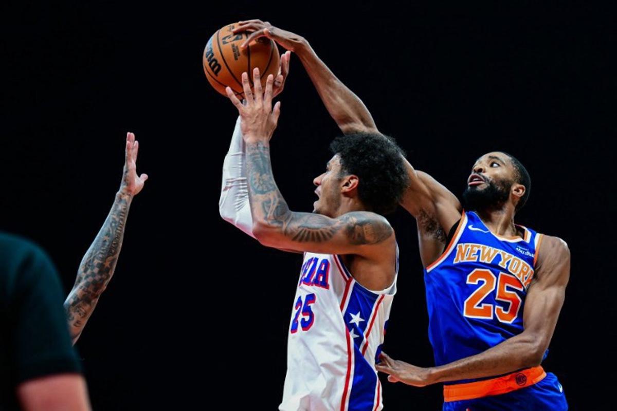 New York Knicks' #25 Mikal Bridges (R) defends against Philadelphia 76ers' #25 Dominick Barlow during the NBA basketball game between the New York Knicks and the Philadelphia 76ers at the Etihad Arena in Abu Dhabi on October 4, 2025.  Giuseppe CACACE / AFP