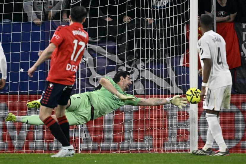 Real Madrid's Belgian goalkeeper #01 Thibaut Courtois clears the ball during the Spanish league football match between CA Osasuna and Real Madrid CF at El Sadar Stadium in Pamplona on February 21, 2026.  ANDER GILLENEA / AFP