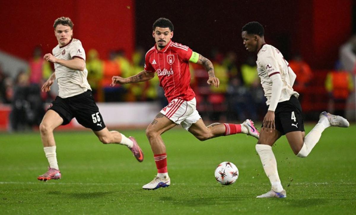 Nottingham Forest's English midfielder #10 Morgan Gibbs-White (C) chases down Midtjylland's Senegalese defender #04 Ousmane Diao (R) during the UEFA Europa League round of 16, first leg football match between Nottingham Forest and FC Midtjylland at The City Ground in Nottingham, central England, on March 12, 2026.  Oli SCARFF / AFP