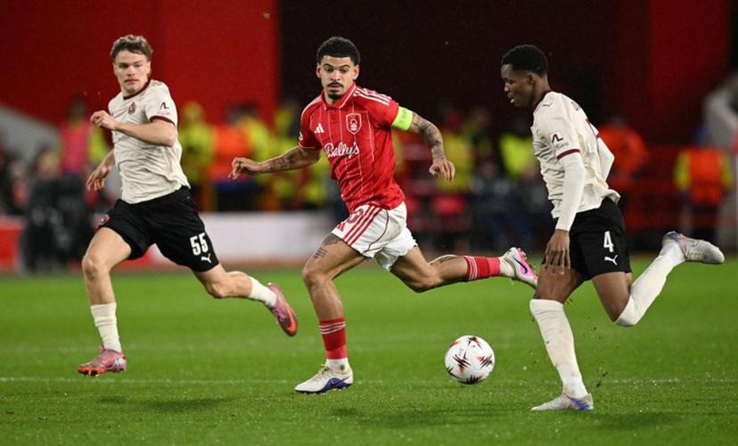 Nottingham Forest's English midfielder #10 Morgan Gibbs-White (C) chases down Midtjylland's Senegalese defender #04 Ousmane Diao (R) during the UEFA Europa League round of 16, first leg football match between Nottingham Forest and FC Midtjylland at The City Ground in Nottingham, central England, on March 12, 2026.  Oli SCARFF / AFP