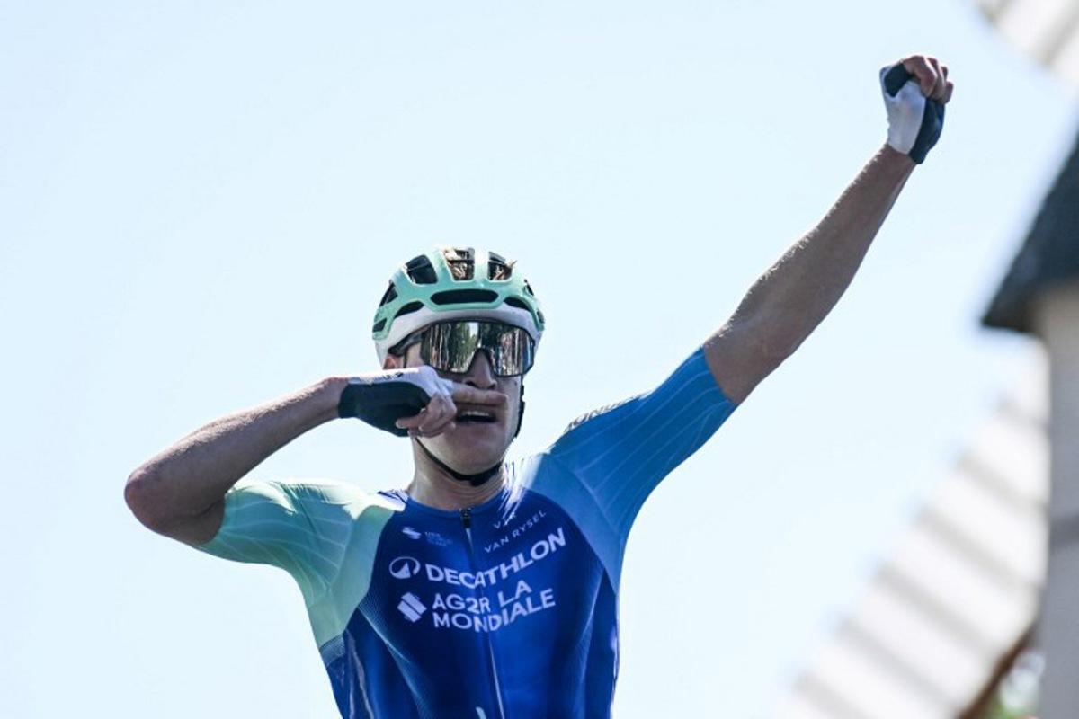Decathlon-AG2R La Mondiale's French rider Dorian Godon gestures as he crosses the finish line to win the men's Elite race of the French National Road Cycling championships, in Les Herbiers, western France, on June 29, 2025.  Sebastien Salom-Gomis / AFP