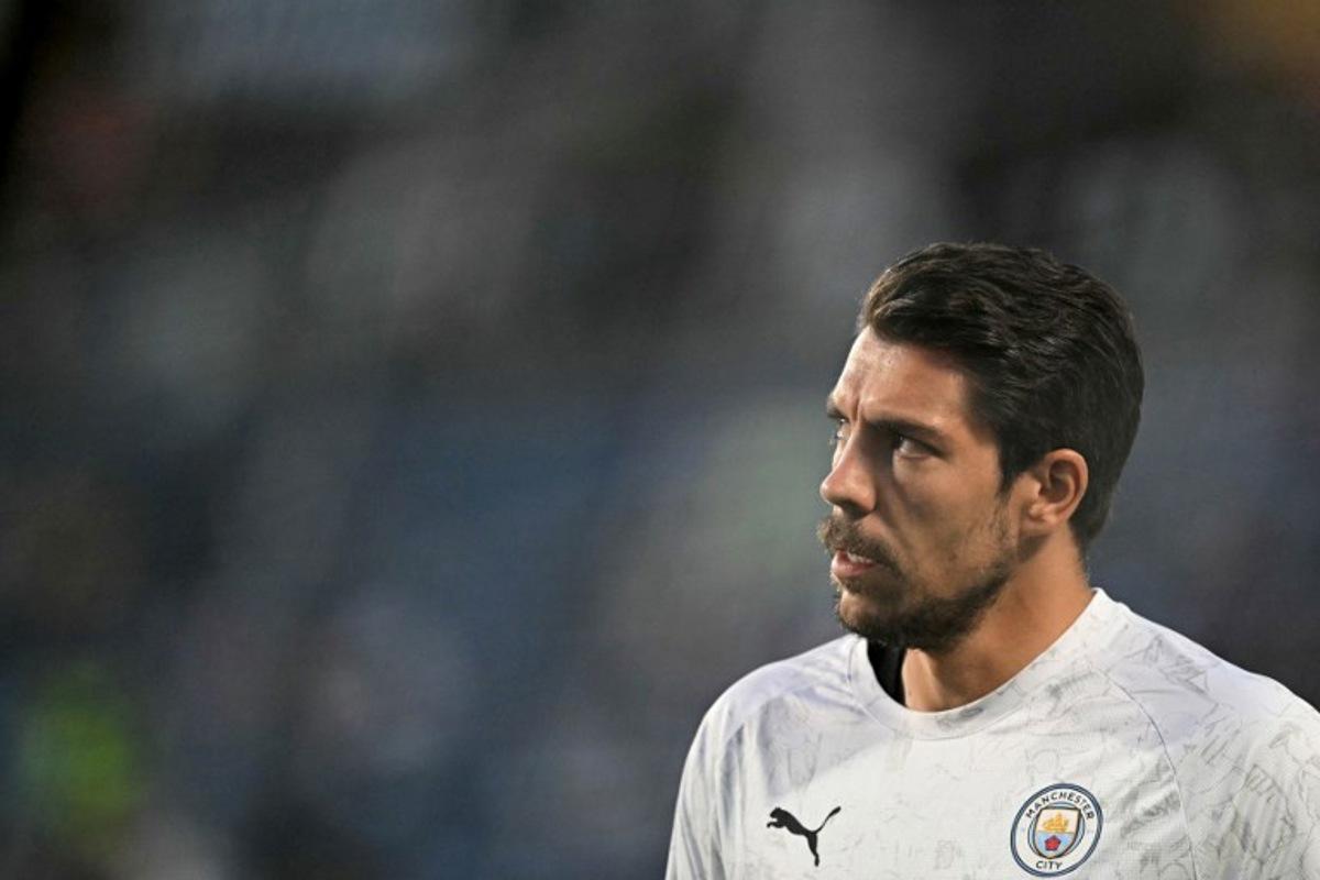 Manchester City's German goalkeeper #18 Stefan Ortega looks on during the warmup ahead of the FIFA Club World Cup 2025 round of 16 football match between England's Manchester City and Saudi's Al-Hilal at the Camping World stadium in Orlando on June 30, 2025.  PATRICIA DE MELO MOREIRA / AFP