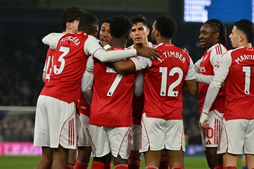 Arsenal's English midfielder #07 Bukayo Saka (C) celebrates with teammates after scoring the opening goal of the English Premier League football match between Brighton and Hove Albion and Arsenal at the American Express Community Stadium in Brighton, southern England on March 4, 2026.  Glyn KIRK / AFP