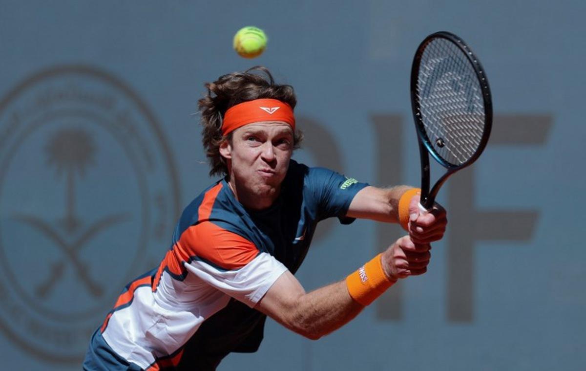 Russia's Andrey Rublev plays a return against Kazakstan's Alexander Bublik during their 2025 ATP Tour Madrid Open tennis tournament third round singles match at the Caja Magica in Madrid, on April 27, 2025.  Thomas COEX / AFP