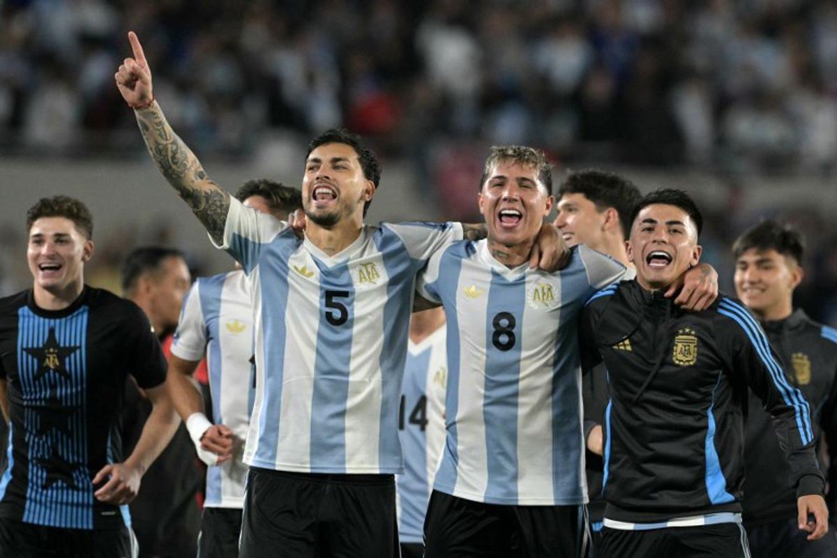 Argentina's forward #09 Julian Alvarez, Argentina's midfielder #05 Leandro Paredes, Argentina's midfielder #08 Enzo Fernandez and Argentina's midfielder #11 Thiago Almada celebrate their victory at the end of the 2026 FIFA World Cup South American qualifiers football match between Argentina and Brazil at the Mas Monumental stadium in Buenos Aires province, on March 25, 2025.  JUAN MABROMATA / AFP