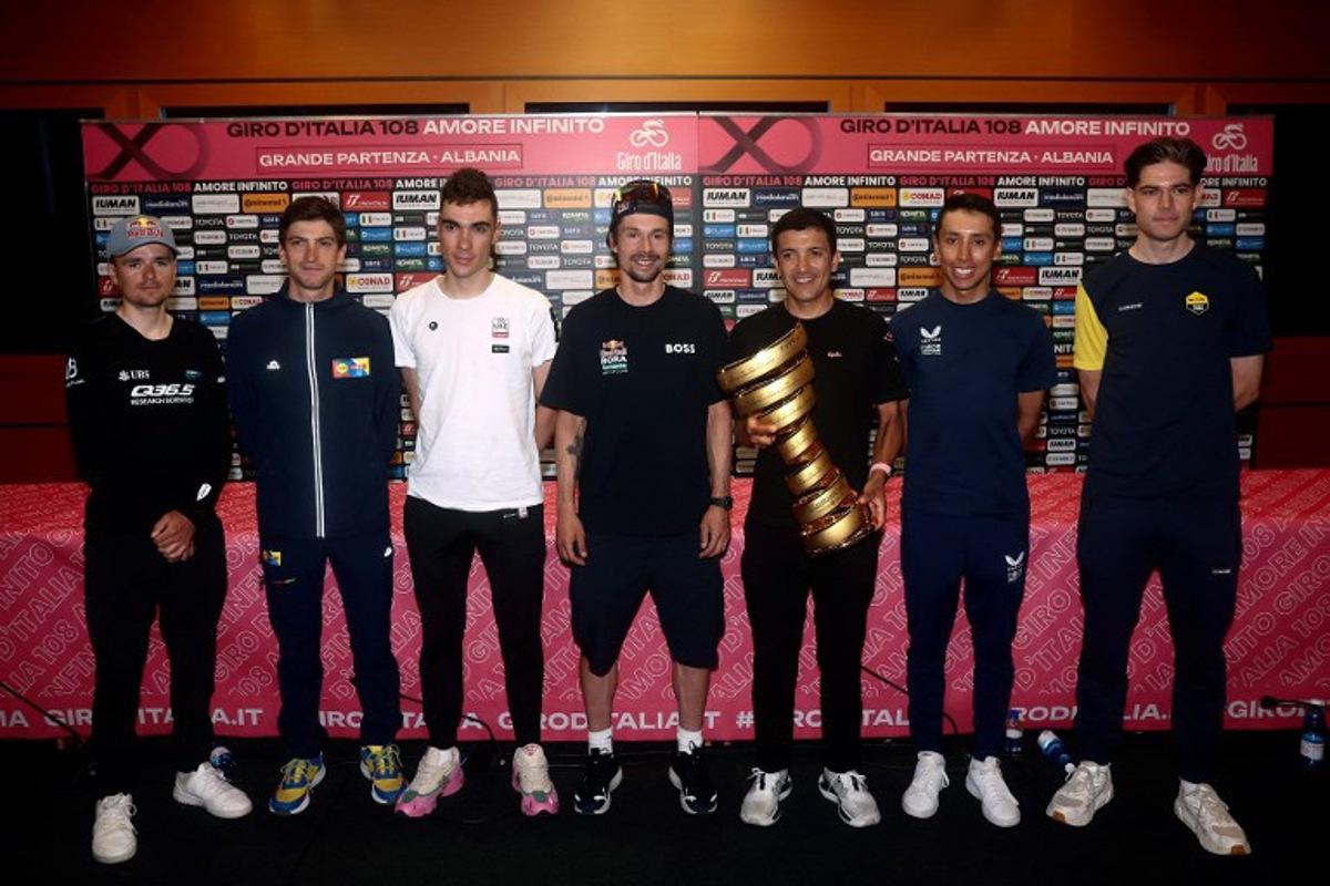 (FROM L) Q36.5 Pro Cycling Team's British rider Tom Pidcock, Lidl - Trek team's Italian rider Giulio Ciccone, UAE Team Emirates XRG's Spanish rider Juan Ayuso, Red Bull-Bora-Hansgrohe's Slovenian rider Primoz Roglic, EF Education - EasyPost's Ecuadorian rider Richard Carapaz, Ineos Grenadiers' Colombian rider Egan Bernal and Team Visma-Lease a Bike's Belgian rider Wout Van Aert pose with the Trofeo Senza Fine during the Top Riders press conference on the eve of the departure of the Giro d'Italia 2025 cycling race, in Tirana, on May 8, 2025.   Luca BETTINI / AFP
