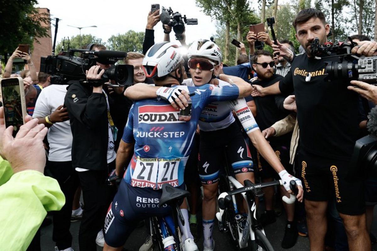 Soudal Quick-Step team's Belgian rider Tim Merlier celebrates with Soudal Quick-Step team's Belgian rider Bert Van Lerberghe after winning the 3rd stage of the 112th edition of the Tour de France cycling race, 178.3 km between Valenciennes and Dunkerque (Dunkirk), Northern France, on July 7, 2025.  BENOIT TESSIER / POOL / AFP