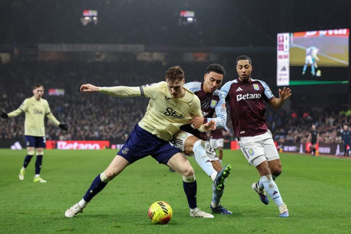 Everton's Irish defender #15 Jake O'Brien (front L) clashes with Aston Villa's English midfielder #27 Morgan Rogers (C) and Aston Villa's Belgian midfielder  #08 Youri Tielemans (R) during the English Premier League football match between Aston Villa and Everton at Villa Park in Birmingham, central England on January 18, 2026.  Darren Staples / AFP