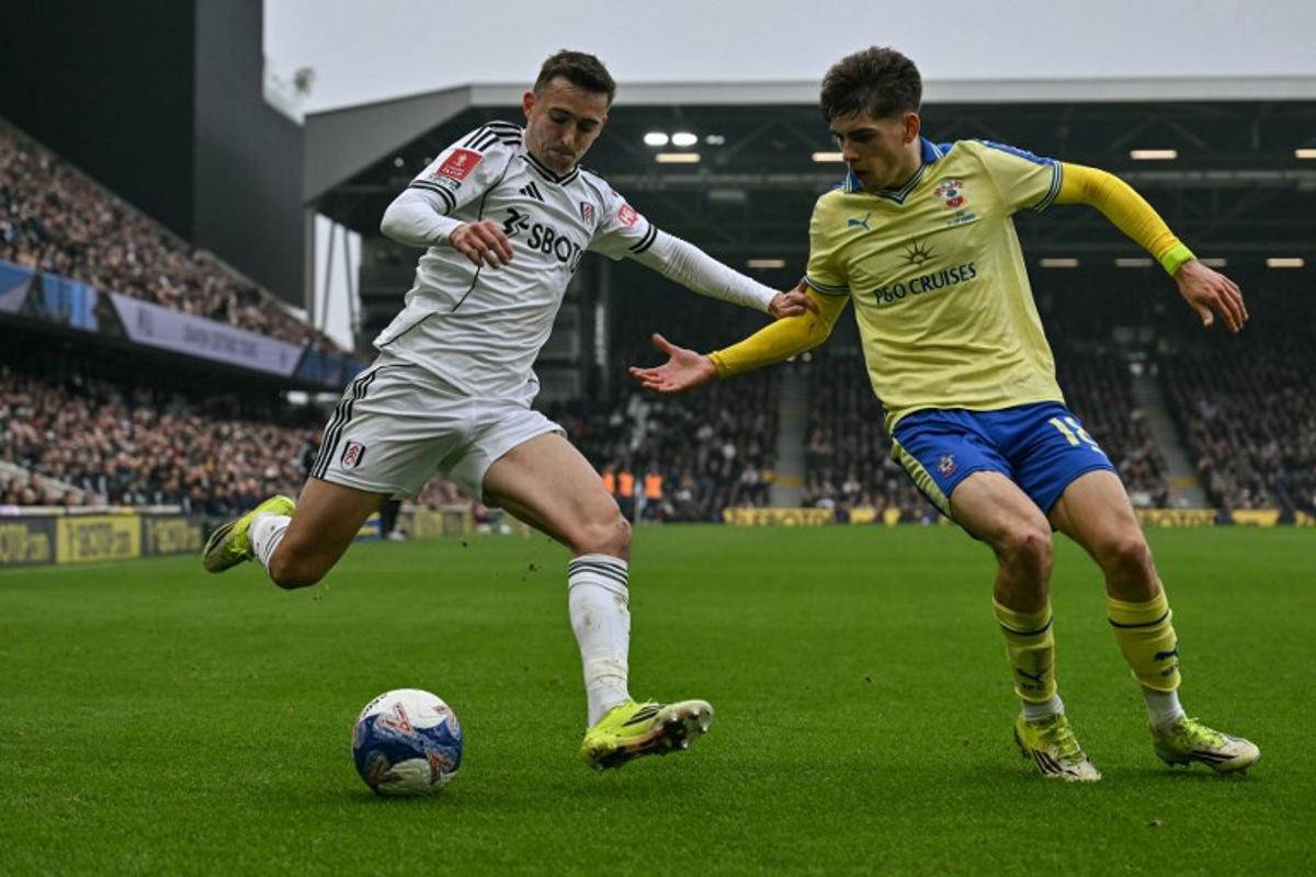 Fulham's Belgian defender #21 Timothy Castagne (L) is challenged by Southampton's English midfielder #18 Tom Fellows (R) during the English FA Cup fifth round football match between Fulham and Southampton at Craven Cottage in London on March 8, 2026.  Glyn KIRK / AFP