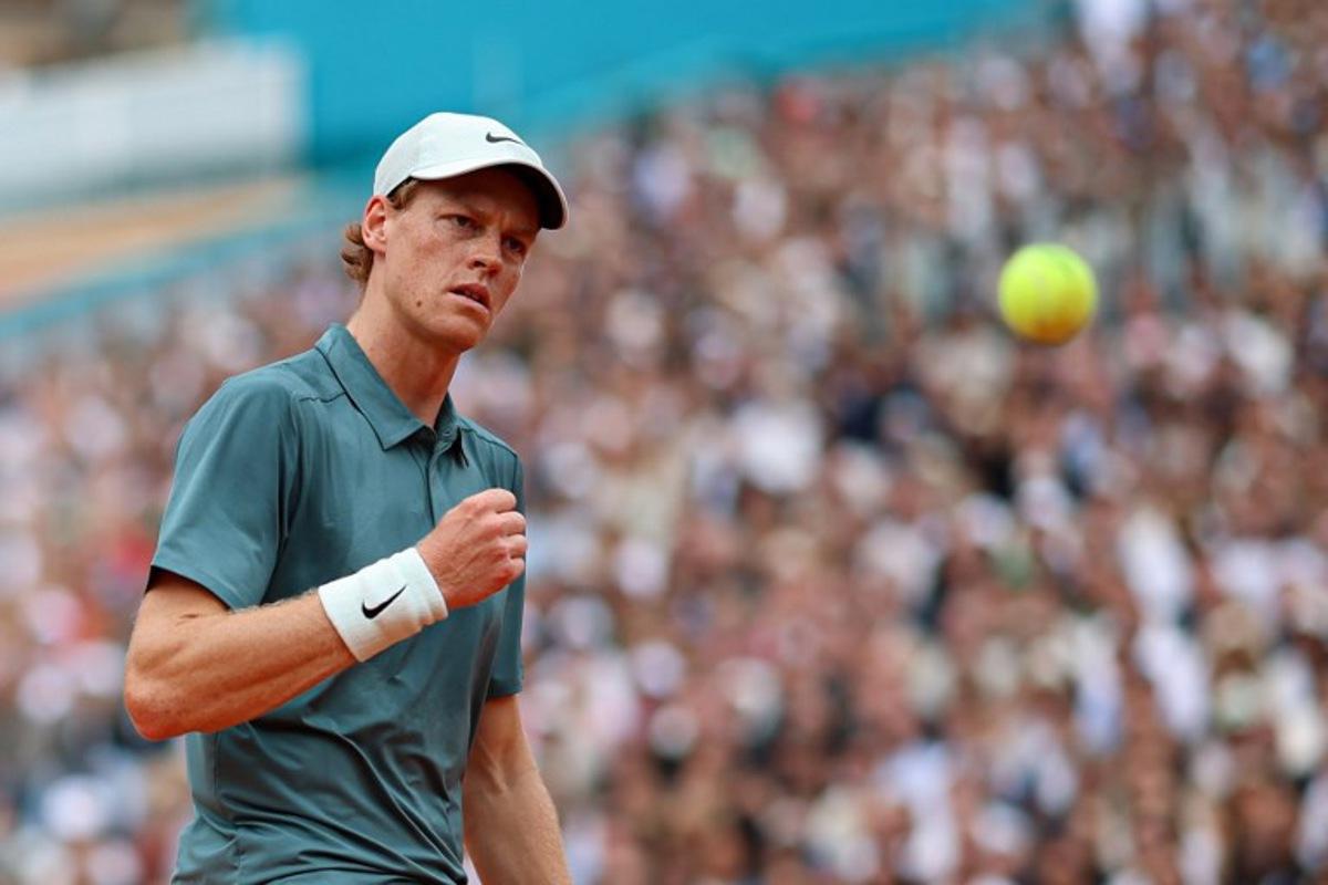Italy's Jannik Sinner reacts as he plays against Spain's Carlos Alcaraz during the Monte Carlo ATP Masters Series Tournament final tennis match on Court Rainier III at the Monte-Carlo Country Club in Roquebrune-Cap-Martin, south-eastern France on April 12, 2026.  Valery HACHE / AFP