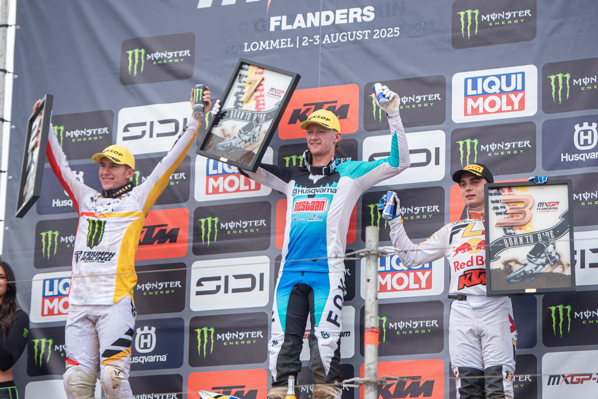 the Netherlands' Kay de Wolf  (C), South Africa's Camden McLellan (L) and Belgium's Sacha Coenen (R) celebrate on the podium after the motocross MX2 Grand Prix Flanders, race 15/20 of the FIM Motocross World Championship, Sunday 03 August 2025 in Lommel. BELGA PHOTO JONAS ROOSENS