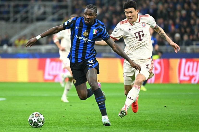 Inter Milan's French forward #09 Marcus Thuram fights for the ball with Bayern Munich's South Korean defender #03 Kim Min-Jae during the UEFA Champions League quarter final second leg football match between Inter Milan and Bayern Munich at the San Siro stadium in Milan on April 16, 2025.  Alberto PIZZOLI / AFP
