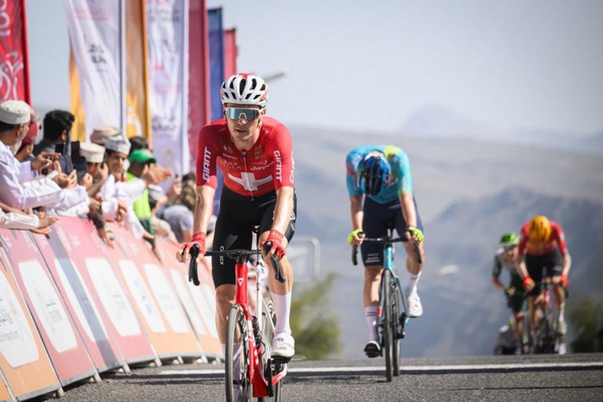 Team Jayco AlUla Swiss rider Mauro Schmid crosses the finish line to win the 3d stage of the Tour of Oman cycling race from Samail "Al Fayhaa Resthouse" to Misfat Al Abriyeen, on February 9, 2026.  Loic VENANCE / AFP