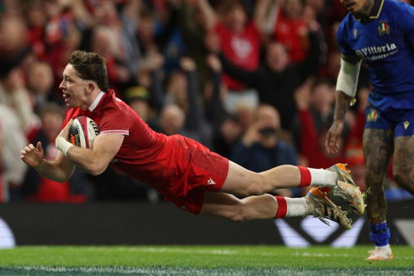 Wales' fly-half Dan Edwards dives over the line to score their fourth try during the Six Nations international rugby union match between Wales and Italy at the Principality Stadium in Cardiff, southern Wales on March 14, 2026.  Adrian Dennis / AFP