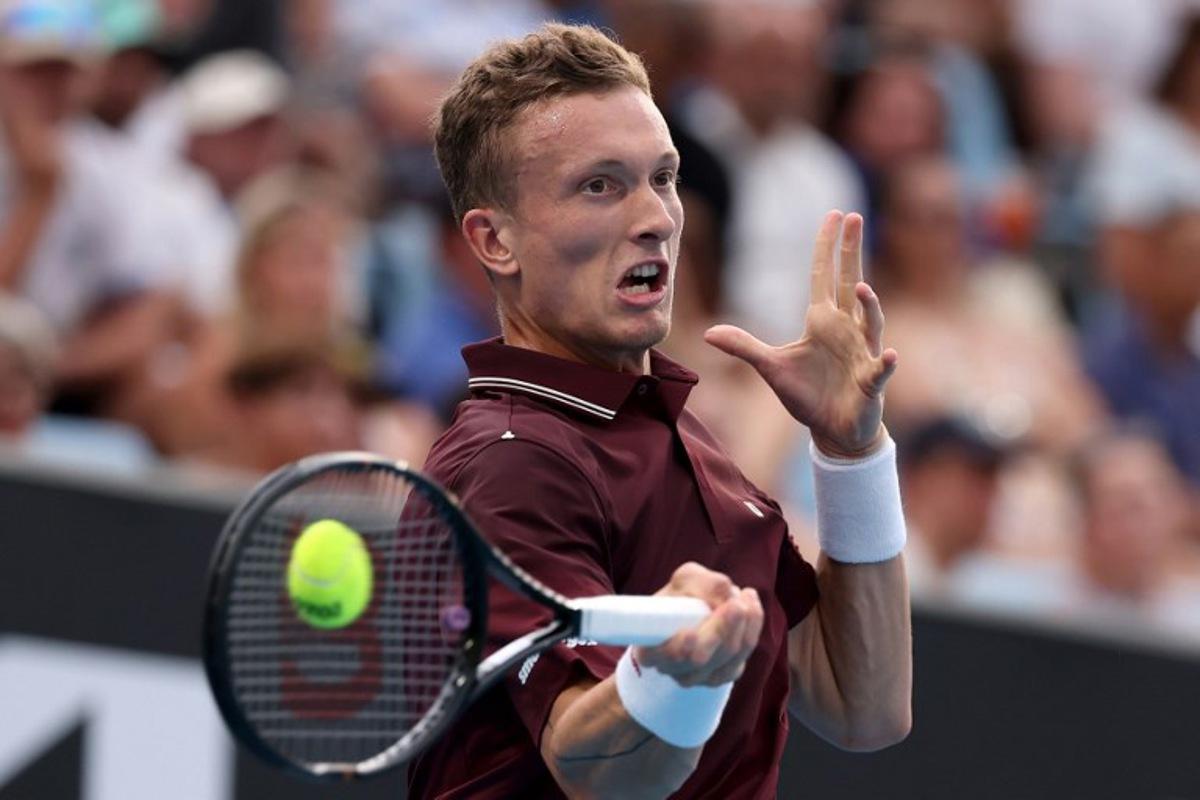 Czech Republic's Jiri Lehecka hits a return to France's Arthur Gea during their men's singles match on day two of the Australian Open tennis tournament in Melbourne on January 19, 2026.  Martin KEEP / AFP