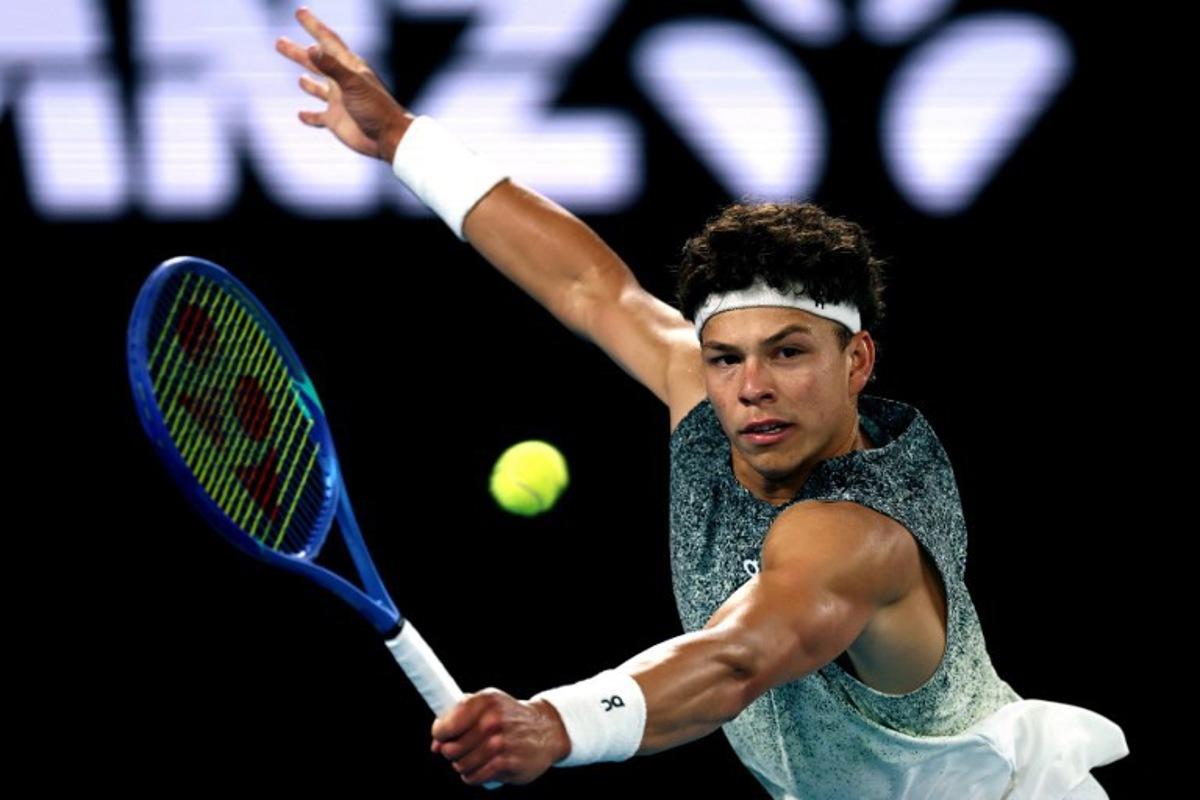 USA's Ben Shelton hits a return to Italy's Jannik Sinner during their men's singles quarter-final match on day eleven of the Australian Open tennis tournament in Melbourne on January 28, 2026.  IZHAR KHAN / AFP