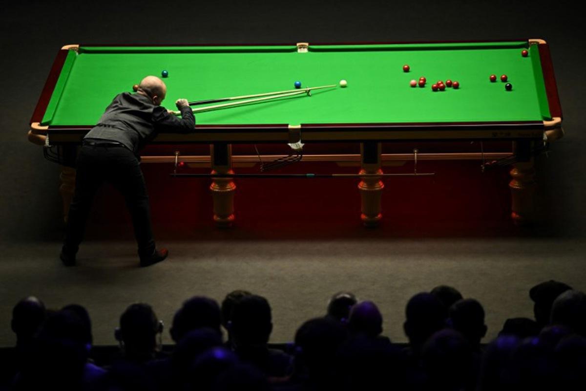 Belgium's Luca Brecel plays a shot against England's Mark Selby during the evening session on day two of their World Championship Snooker final match at The Crucible in Sheffield, northern England on May 1, 2023.   Oli SCARFF / AFP