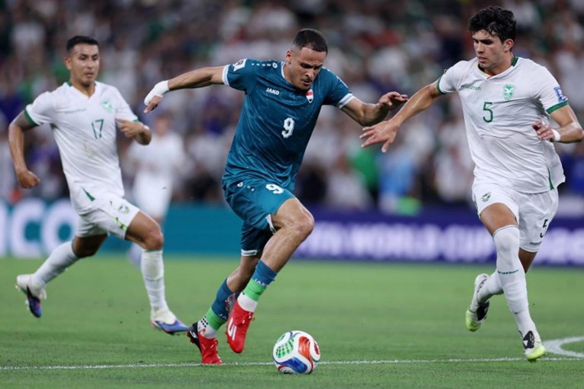 Iraq's forward #09 Ali Al-Hamadi and Bolivia's defender #05 Efrain Morales fight for the ball during the 2026 FIFA World Cup qualifiers final playoff football match between Iraq and Bolivia at the BBVA Stadium in Guadalupe, Nuevo Leon state, Mexico, on March 31, 2026.  Julio Cesar AGUILAR / AFP