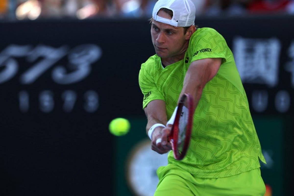 Belgium's Zizou Bergs hits a shot against Poland's Hubert Hurkacz during their men's singles match on day three of the Australian Open tennis tournament in Melbourne on January 20, 2026.  IZHAR KHAN / AFP