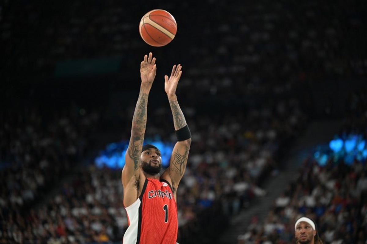 Canada's #01 Nickeil Alexander-Walker takes a shot in the men's quarterfinal basketball match between France and Canada during the Paris 2024 Olympic Games at the Bercy Arena in Paris on August 6, 2024.  Damien MEYER / AFP