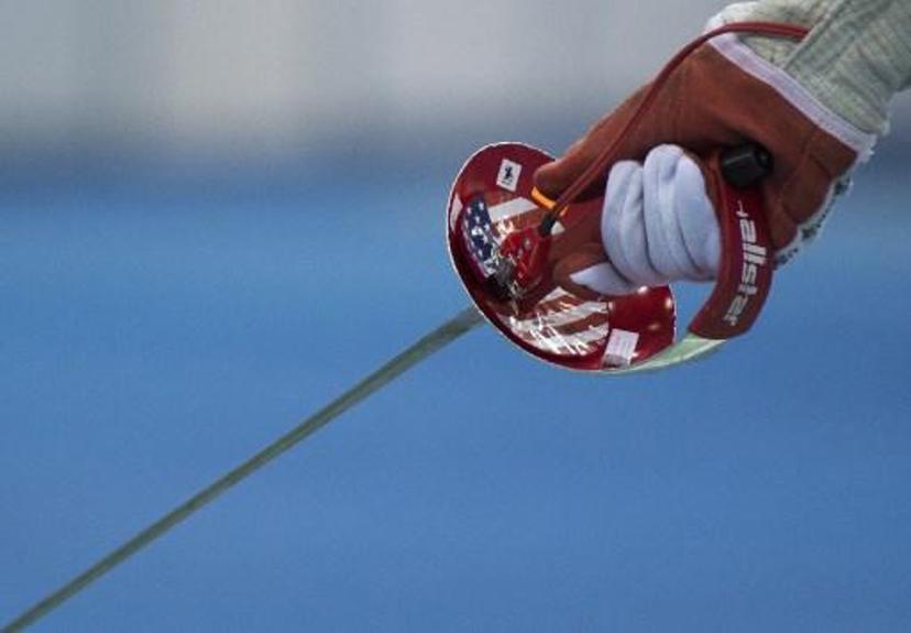 A US flag is seen on the weapon of US athlete Ibtihaj Muhammad during the Women's Team Sabre competition at the World Fencing Championships on July 25, 2017 in Leipzig, eastern Germany.  ROBERT MICHAEL / AFP