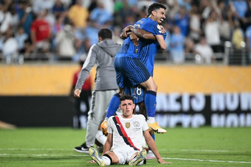 Manchester City's English midfielder #47 Phil Foden reacts while players of Al-Hilal celebrate at the end of the FIFA Club World Cup 2025 round of 16 football match between England's Manchester City and Saudi's Al-Hilal at the Camping World stadium in Orlando on June 30, 2025.  PATRICIA DE MELO MOREIRA / AFP