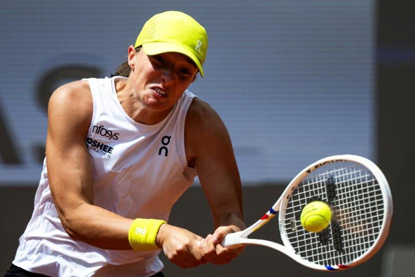 Poland's Iga Swiatek plays a backhand return to US' Danielle Collins during their women's singles match of the WTA Rome Open tennis tournament at Foro Italico in Rome on May 10, 2025.   MARCO BERTORELLO / AFP